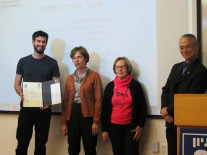 Ido Greenfeld receiving diploma and scholarship from the Zohar family