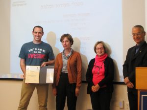 Rea David receiving diploma and scholarship from the Zohar family